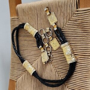 Gold tone and black metal faux leather belt, hook closure, braided, woman's face
